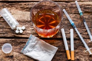 alcohol cigarettes and drugs pernicious habits on wooden background