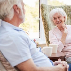 bigstock-senior-couple-sitting-in-chair-258165790_1_621x621