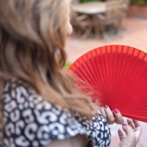 bigstock-red-fan-that-holds-a-woman-wit-458593047_1_621x621