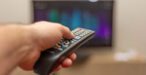 bigstock-A-Person-With-A-Tv-Remote-Cont-330419710-1170x600