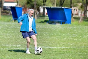 bigstock-old-man-playing-football-89249438_6_928x621